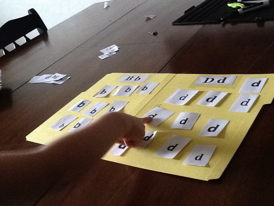 Student touching letters on a letter board